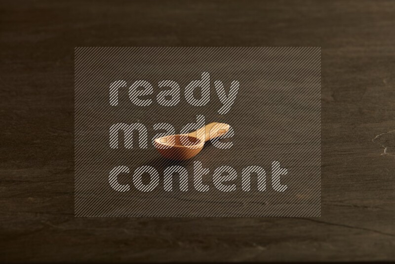 wooden spoon on black slate background