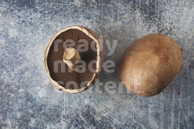 Fresh portobello mushroom topview on a textured blue background