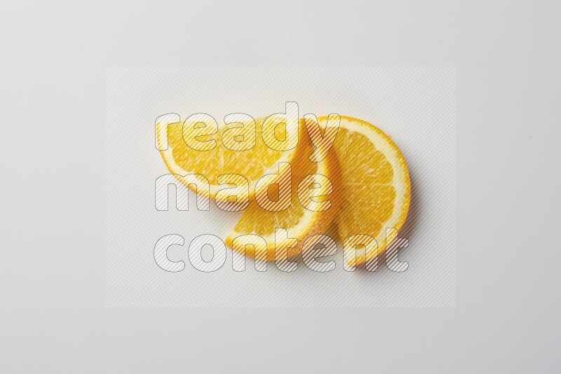Three halves of an orange slices on white background