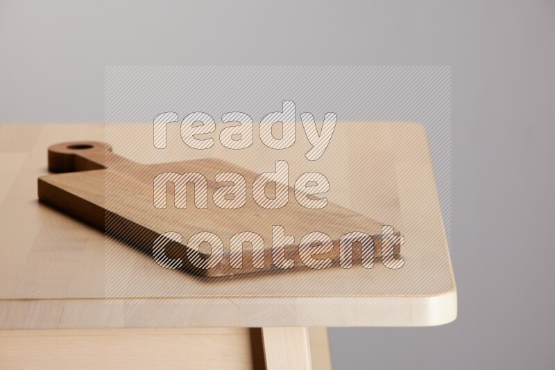 wooden trays and cutting boards on the edge of wooden table
