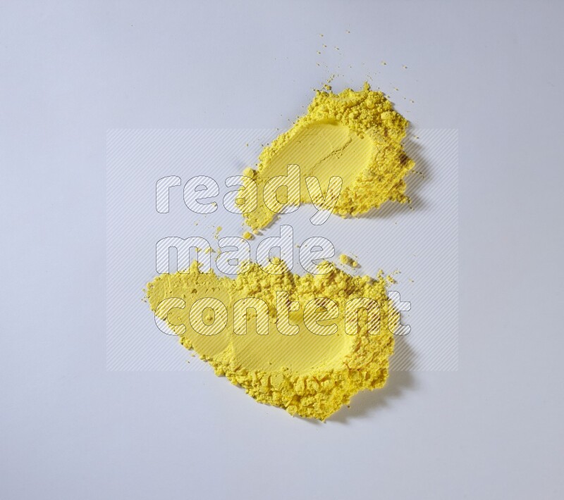 Yellow powder smears on white background