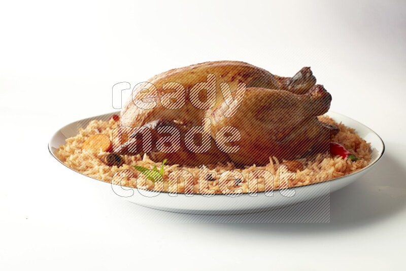 red basmati Rice with whole roasted chicken on a white plate with a silver rim direct on white background