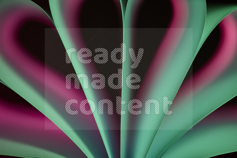 An abstract art piece displaying smooth curves in pink and green gradients created by colored light