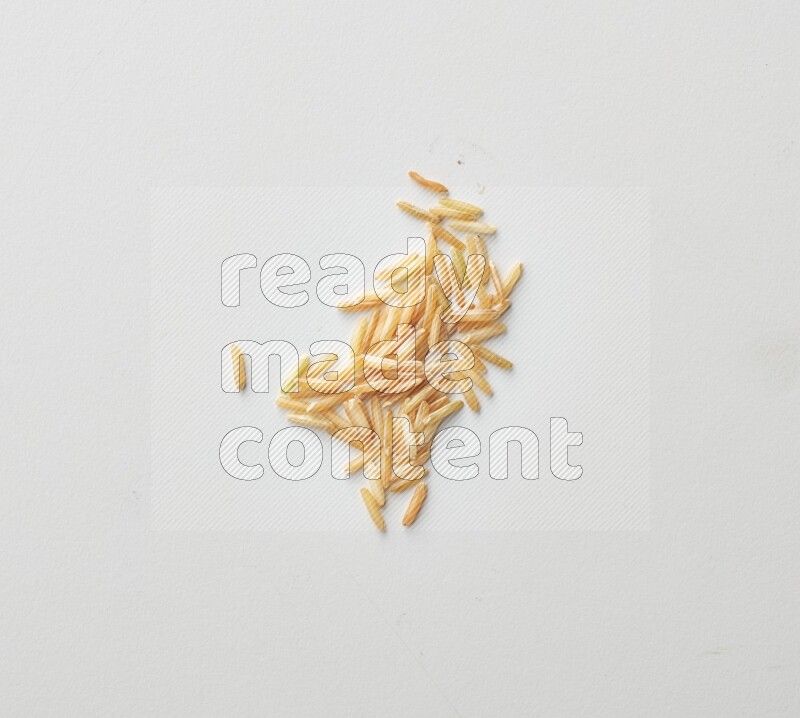 Top-view shot of long grain brown rice on white background