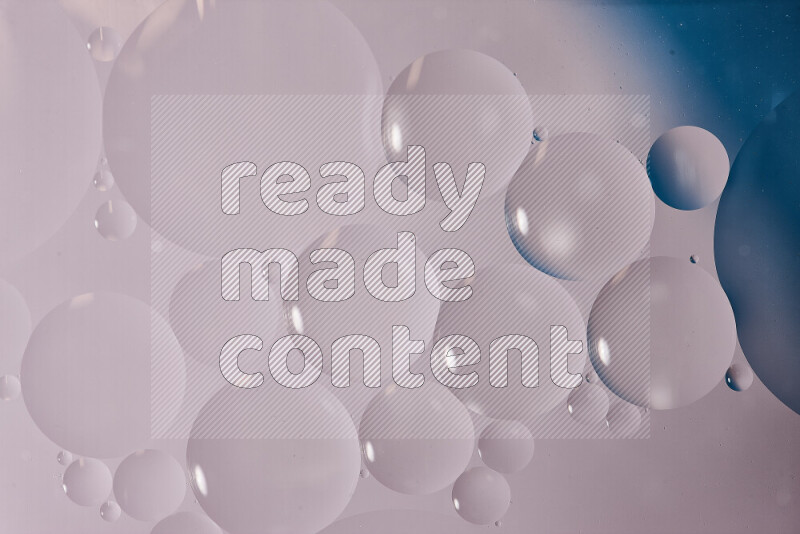 Close-ups of abstract oil bubbles on water surface in shades of white and blue