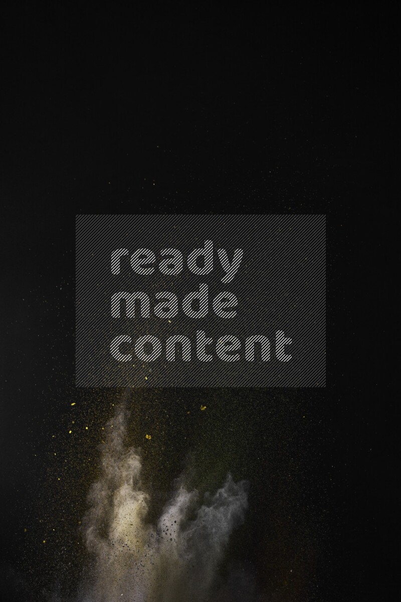 A side view of multicolored powder explosion on black background