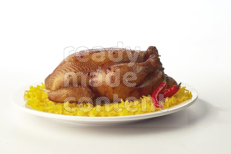 yellow  basmati Rice with  whole roasted chicken on a white rounded plate direct on white background