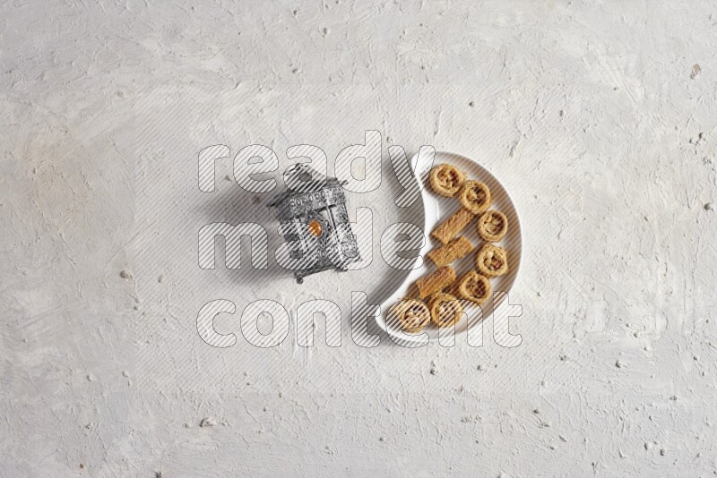 Oriental sweets in a pottery plate with lantern in a light setup