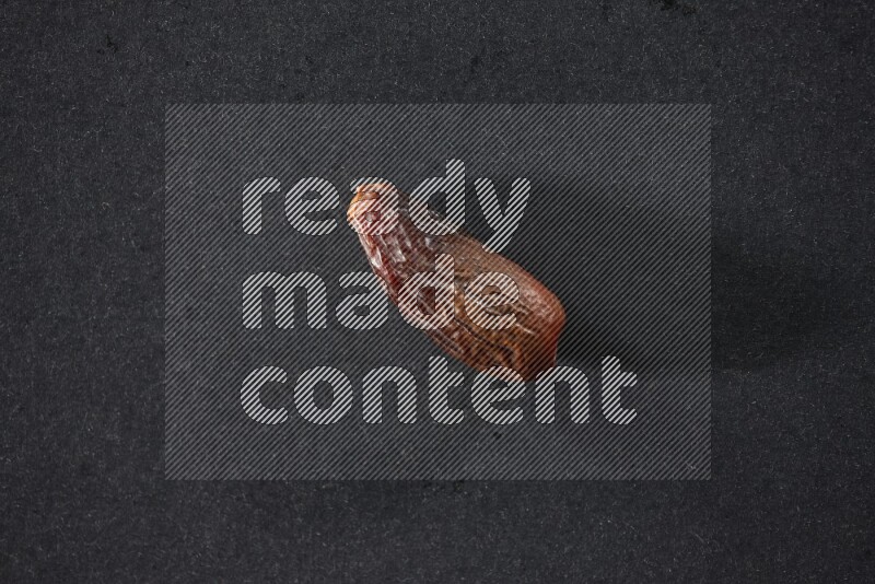 Dried dates on a black background in different angles