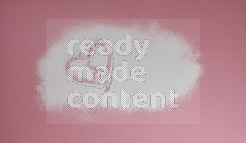 A heart drawn with powder on pink background
