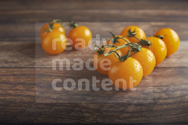yellow cherry tomato vein on a textured wooden background 45 degree