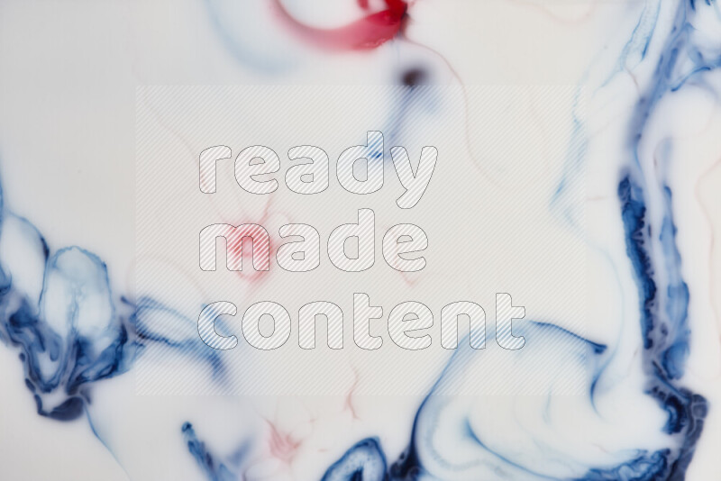 A close-up of abstract swirling patterns in blue, red and white