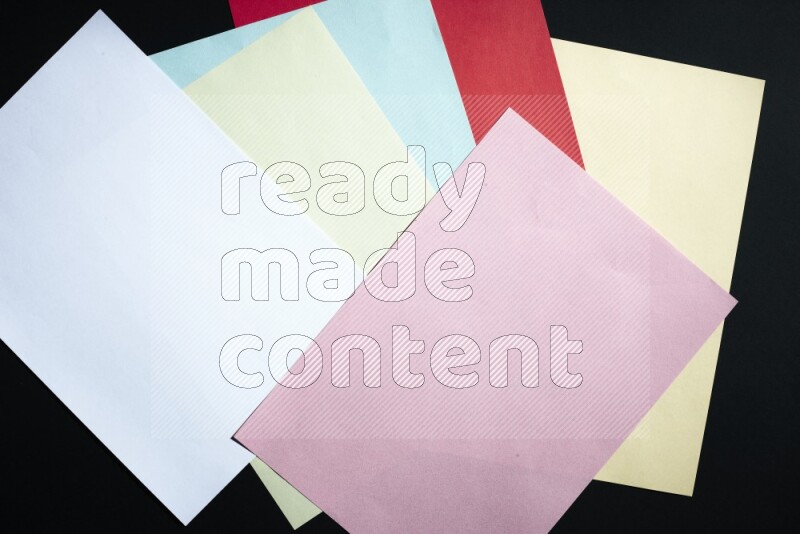 Multicolored paper sheet on black background