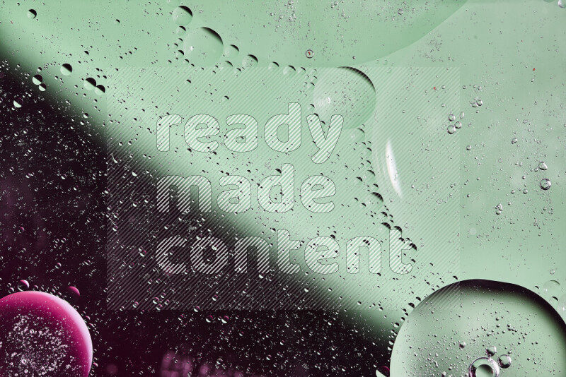 لقطات مقربة لفقاعات من الزيت على سطح الماء باللون الأخضر والوردي