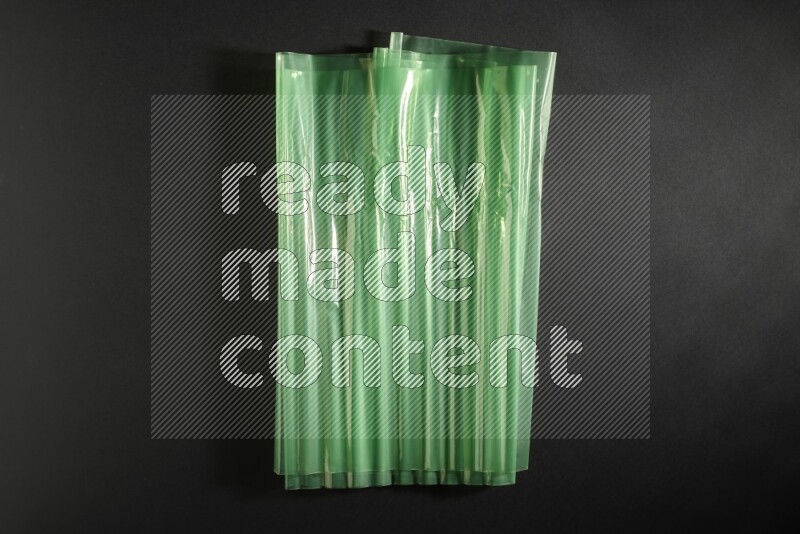 Colored plastic textures on black background