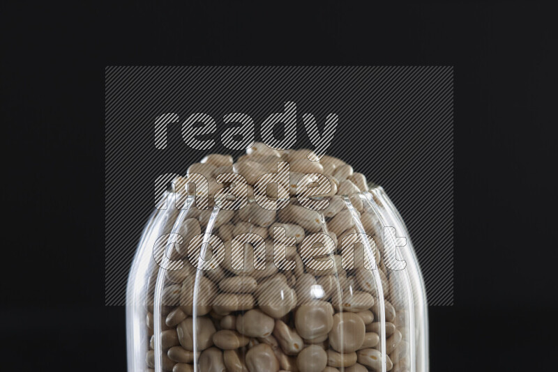 Lupin Beans in a glass jar on black background