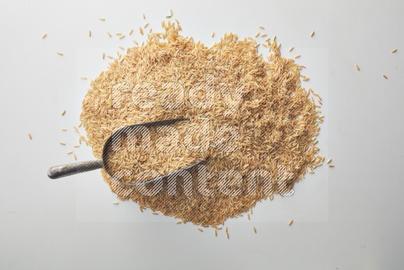 Long grain brown rice on white background