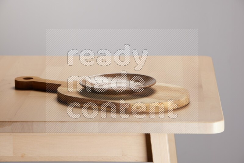 multi colored plate placed on a  wooden oval cutting board on the edge of wooden table
