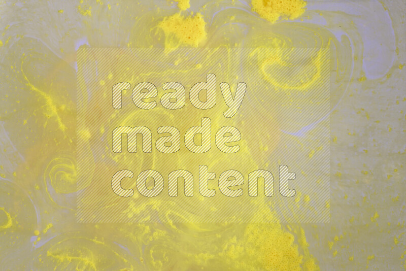 The image captures a dramatic splatter of yellow paint over a white backdrop