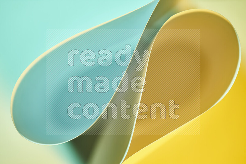 An abstract art of paper folded into smooth curves in green and yellow gradients