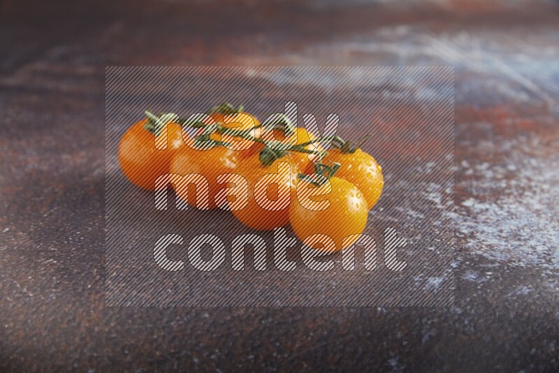 Orange cherry tomato vein on reddish rustic metal background 45 degree