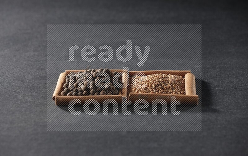 2 squares of cinnamon sticks full of mustard seeds and allspice on black flooring