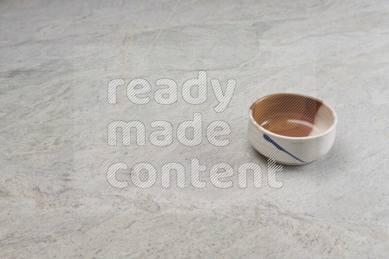 A multicolored pottery bowl on grey marble background