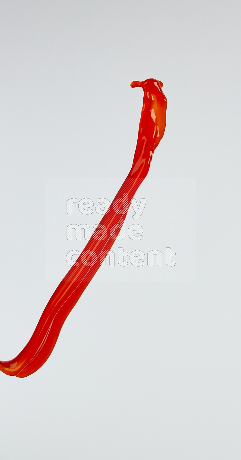 Orange liquid splash and drops on white background
