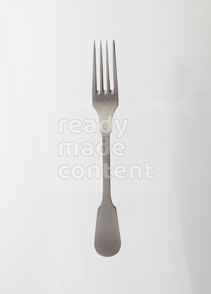 Silver stainless steel fork on white background