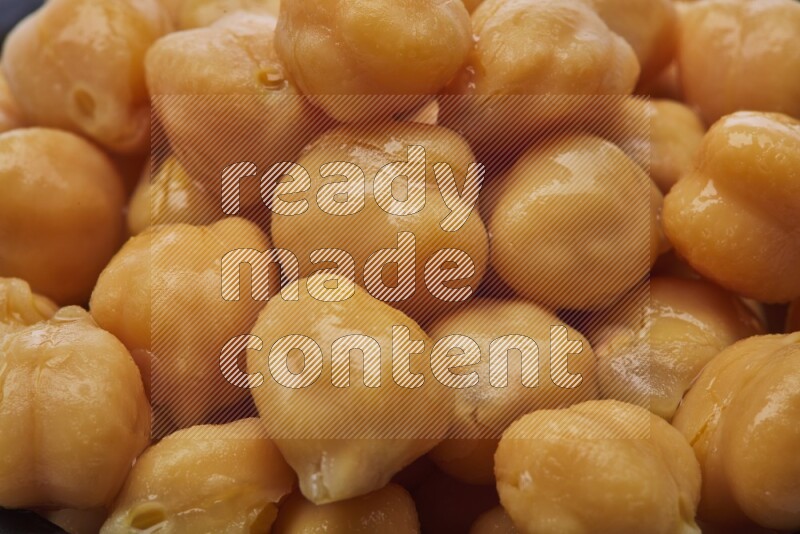 Close up of a boiled chickpeas in a container on white background