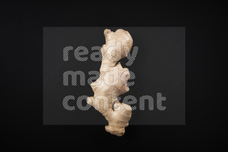 Fresh ginger root on black background
