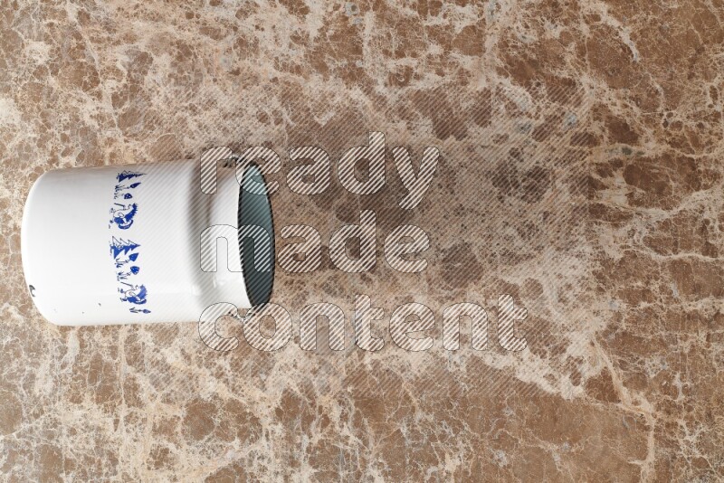 A vintage milk can on beige marble background
