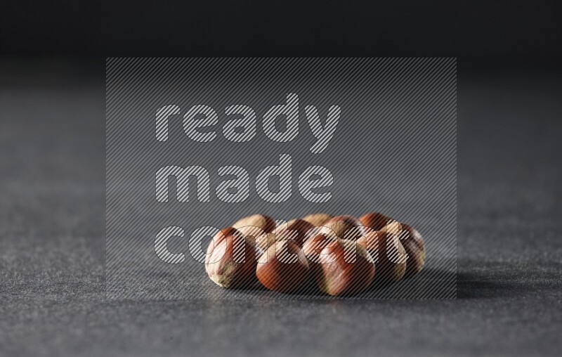 A bunch of hazelnuts on a black background in different angles