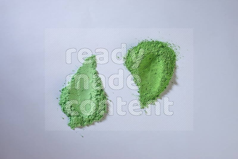 Green powder smears on white background
