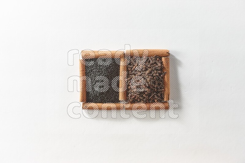 2 squares of cinnamon sticks full of cloves and black seeds on white flooring