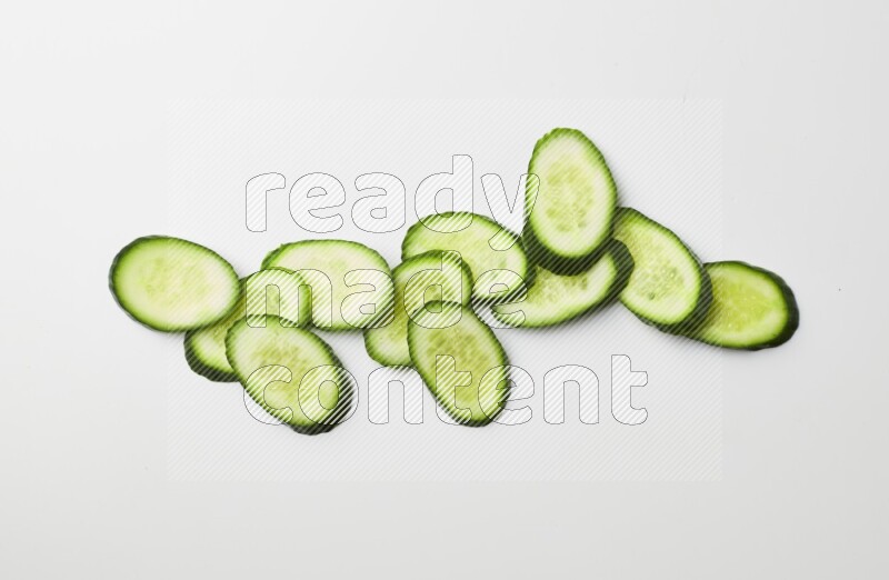 Multiple cucumber slices on white background