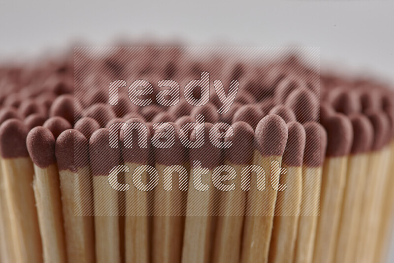 A close-up of a bundle of matches on grey background