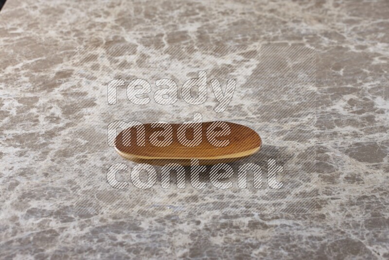 A wooden plate on beige marble background