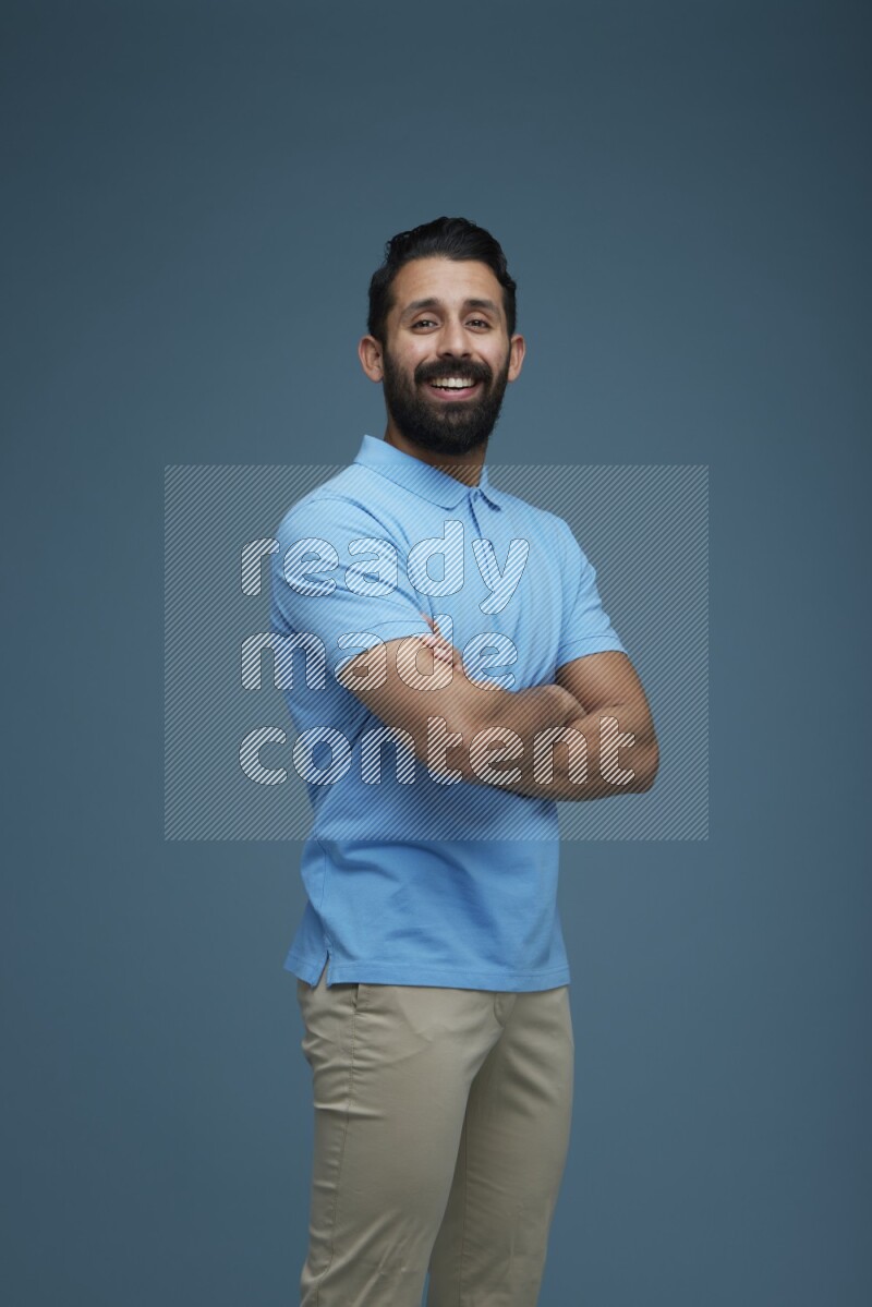 Man posing in a blue background wearing a Blue shirt