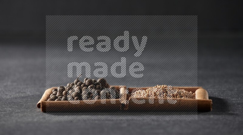 2 squares of cinnamon sticks full of mustard seeds and allspice on black flooring