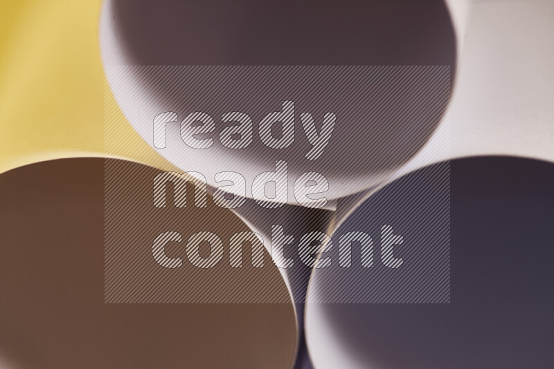 The image shows an abstract paper art with circular shapes in varying shades of grey and warm tones