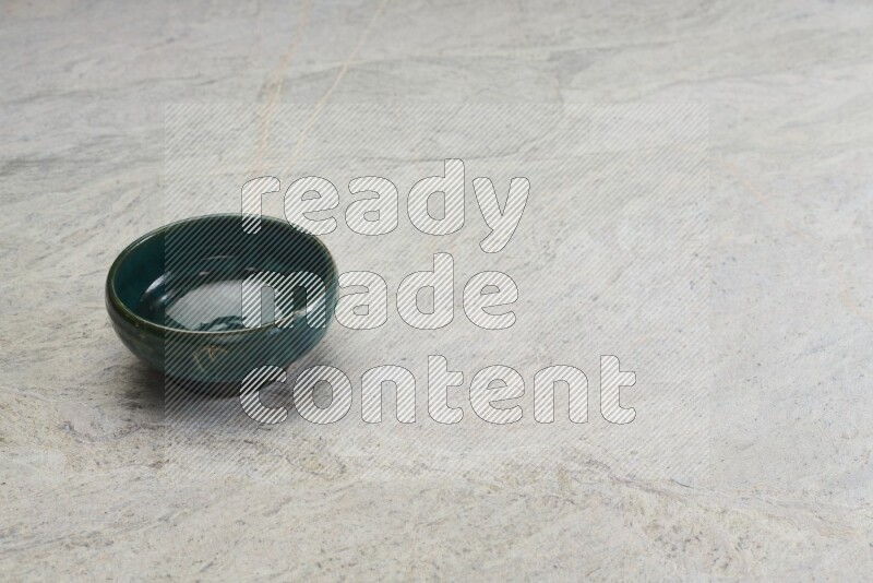 A multicolored pottery bowl on grey marble background