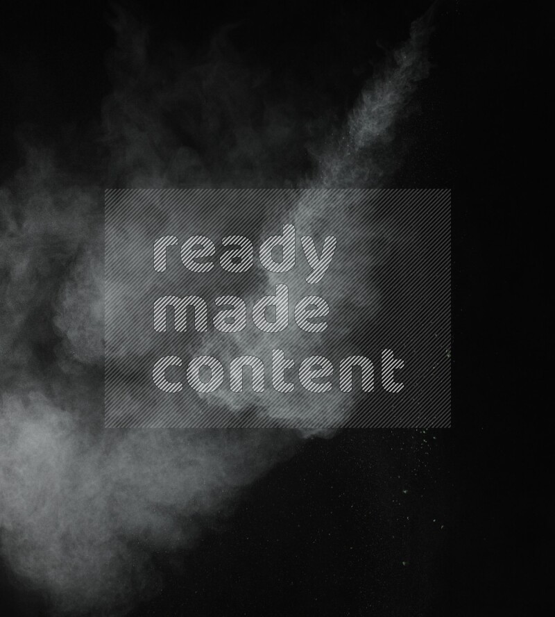 A side view of green powder explosion on black background