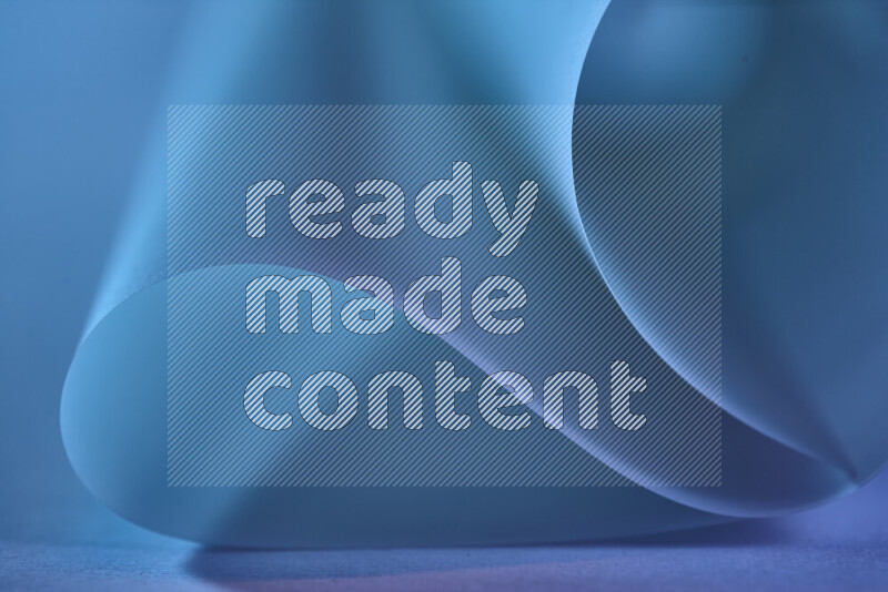 An abstract art piece displaying smooth curves in blue gradients created by colored light