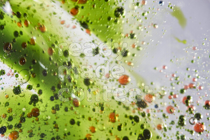 Close-ups of abstract green and red watercolor drops on oil Surface on white background