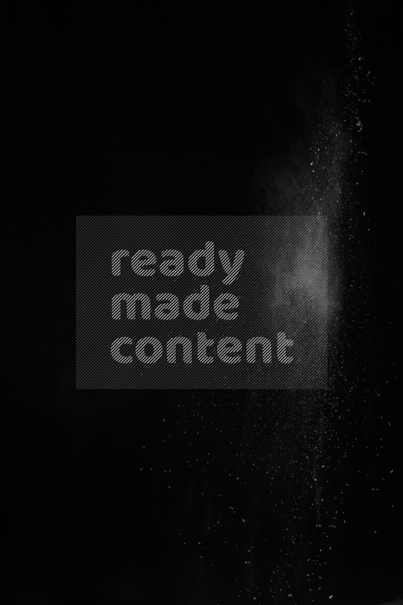 A side view of white powder explosion on black background