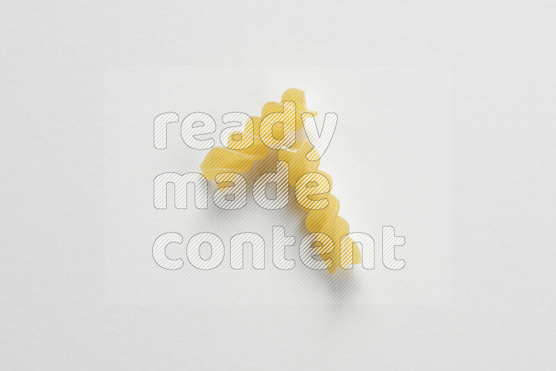 Fusilli pasta on white background