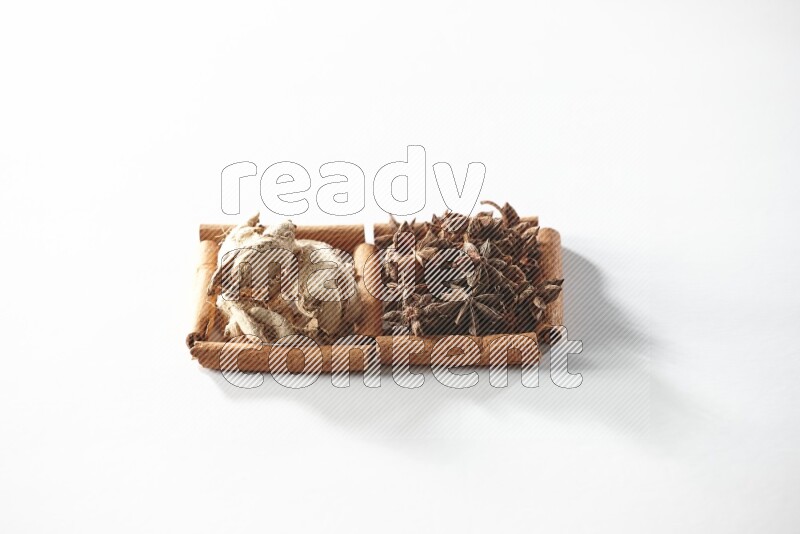2 squares of cinnamon sticks full of star anise and dried ginger on white flooring