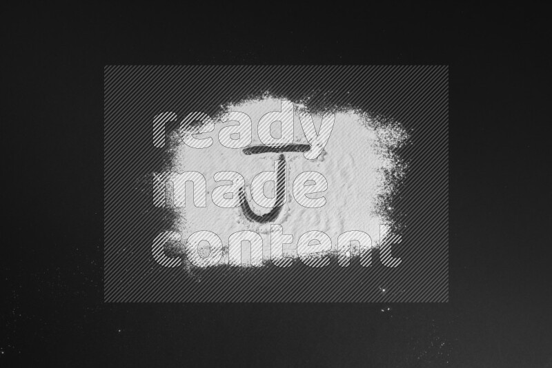 Alphabets written with powder on black background