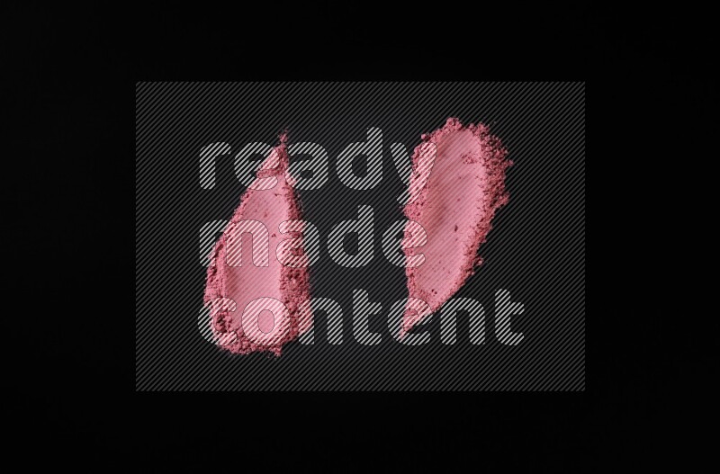 Red powder smears on black background